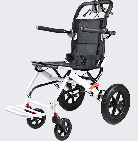 A white compact foldable manual chair completely folded inside a car trunk